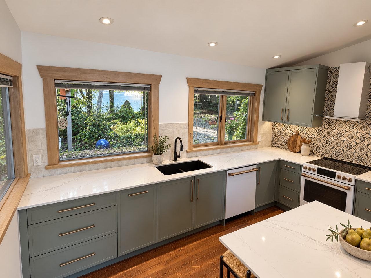 Sage green shaker kitchen with quartz counters and a patterned tile backsplash on Piers Island